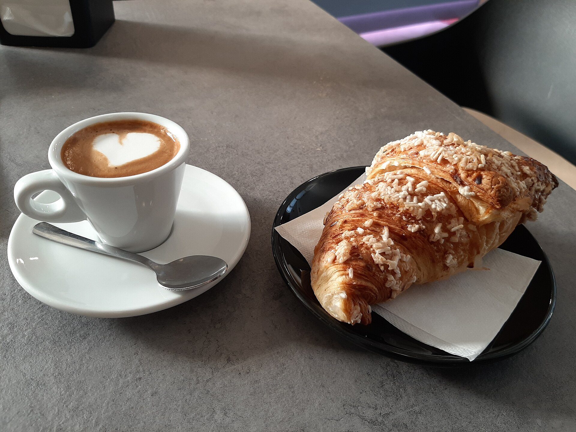 An Italian breakfast: a cornetto and a cappuccino
