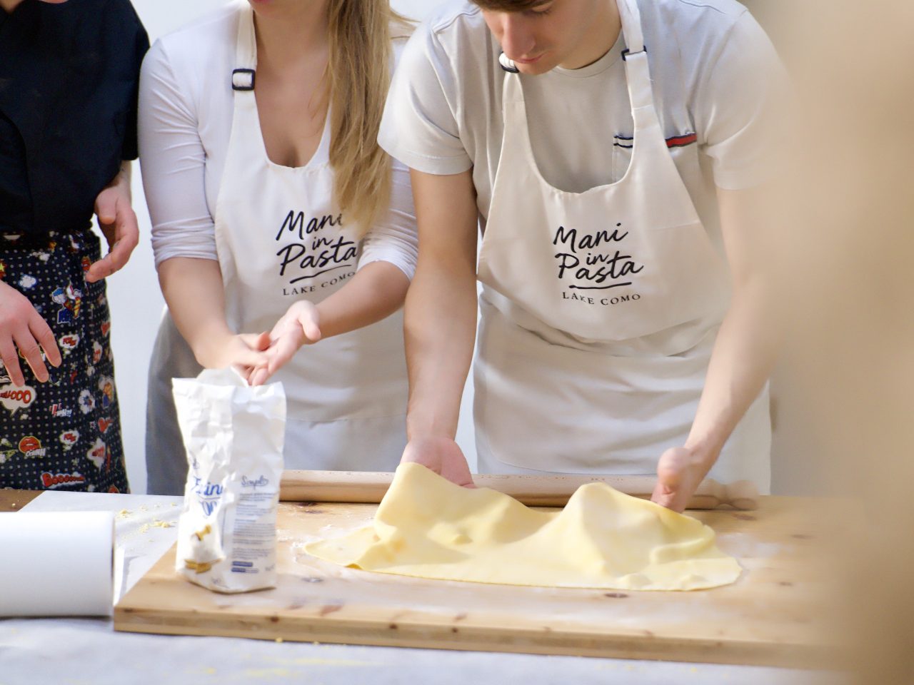 Shaping farfalle by hand and rolling garganelli on the ridged pettine during a pasta class in Como