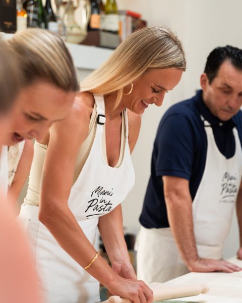 Guests laughing while rolling pasta