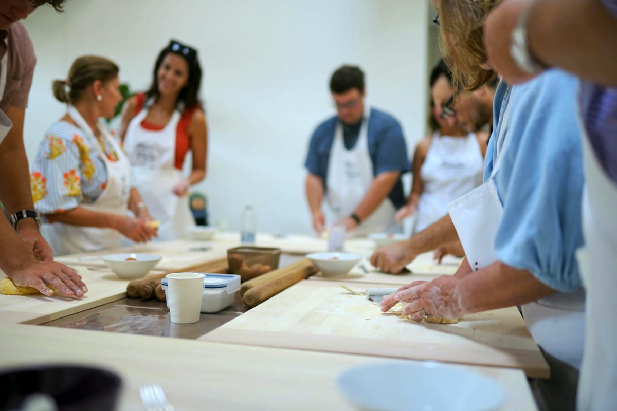 Everyone kneading together at the big table of our Como studio