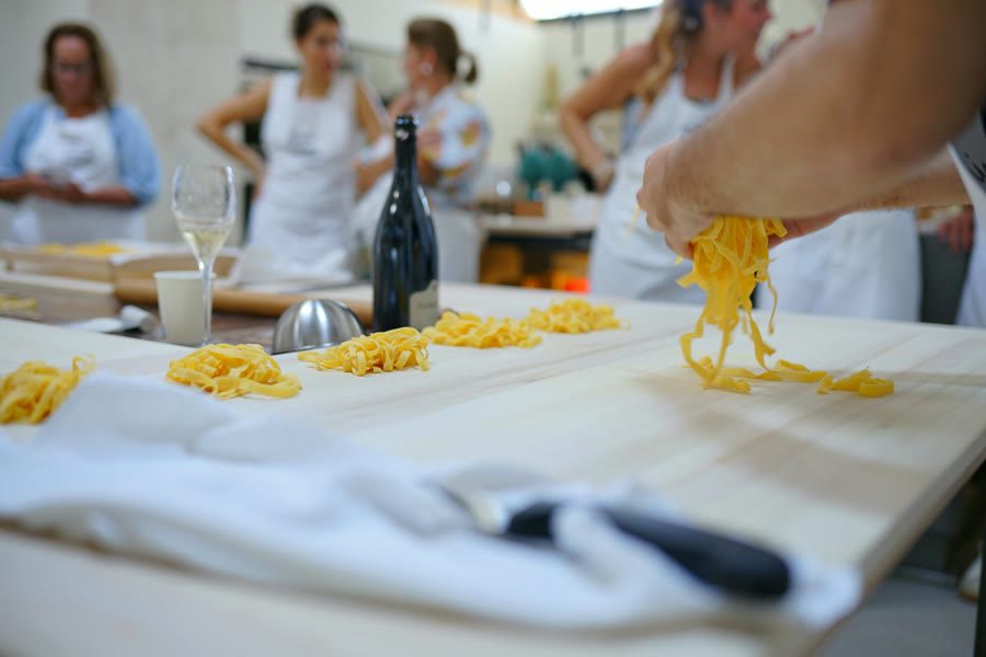 Freshly cut tagliatelle lifted over the board during the class in Como