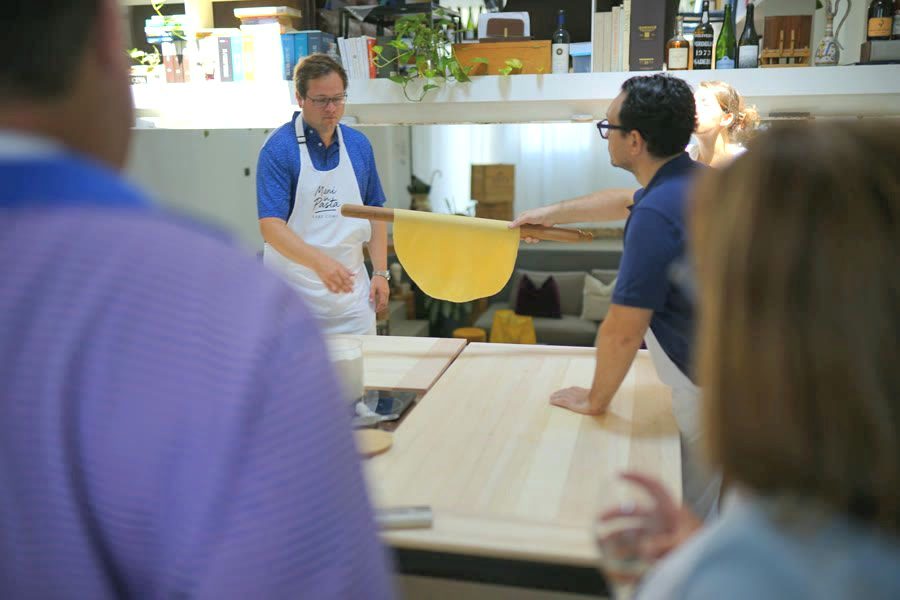 The chef lifts the thin sfoglia during the tagliatelle masterclass